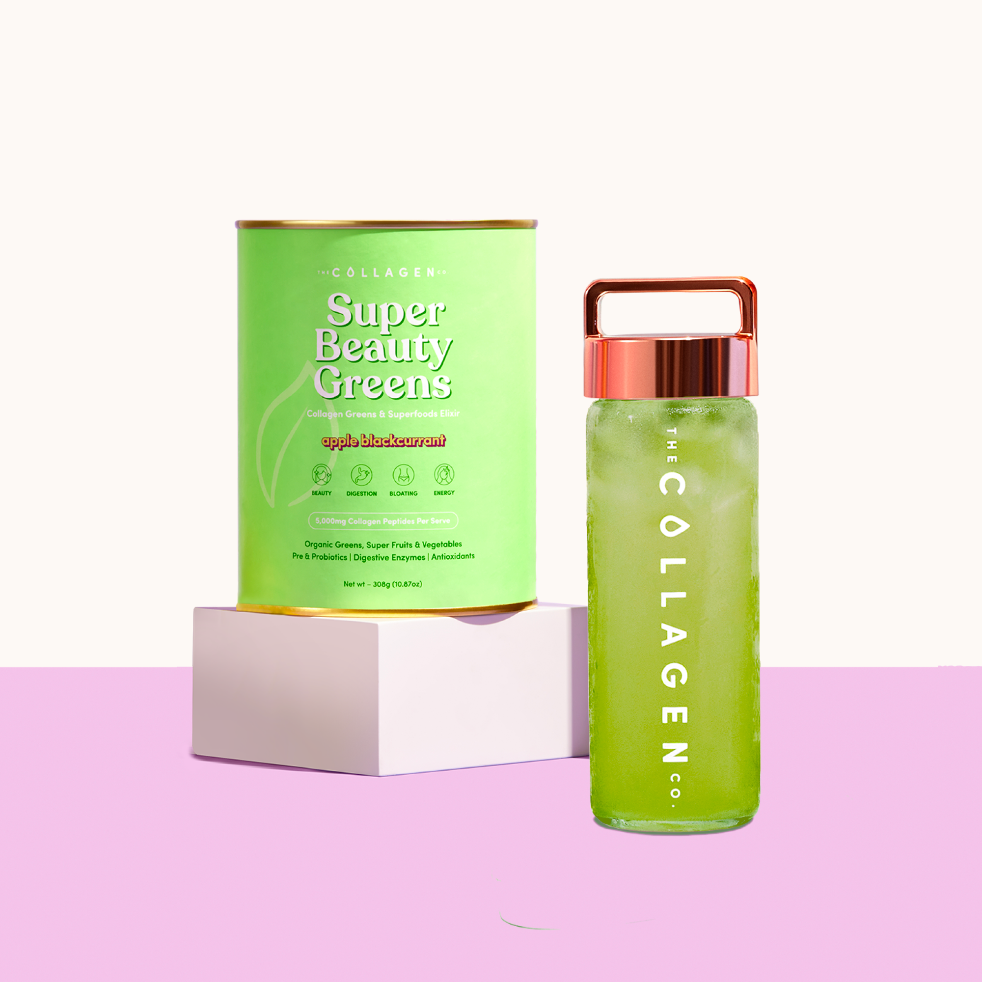 Green Collagen Super Beauty Greens container and matching green drink bottle with copper lid on a pink surface.