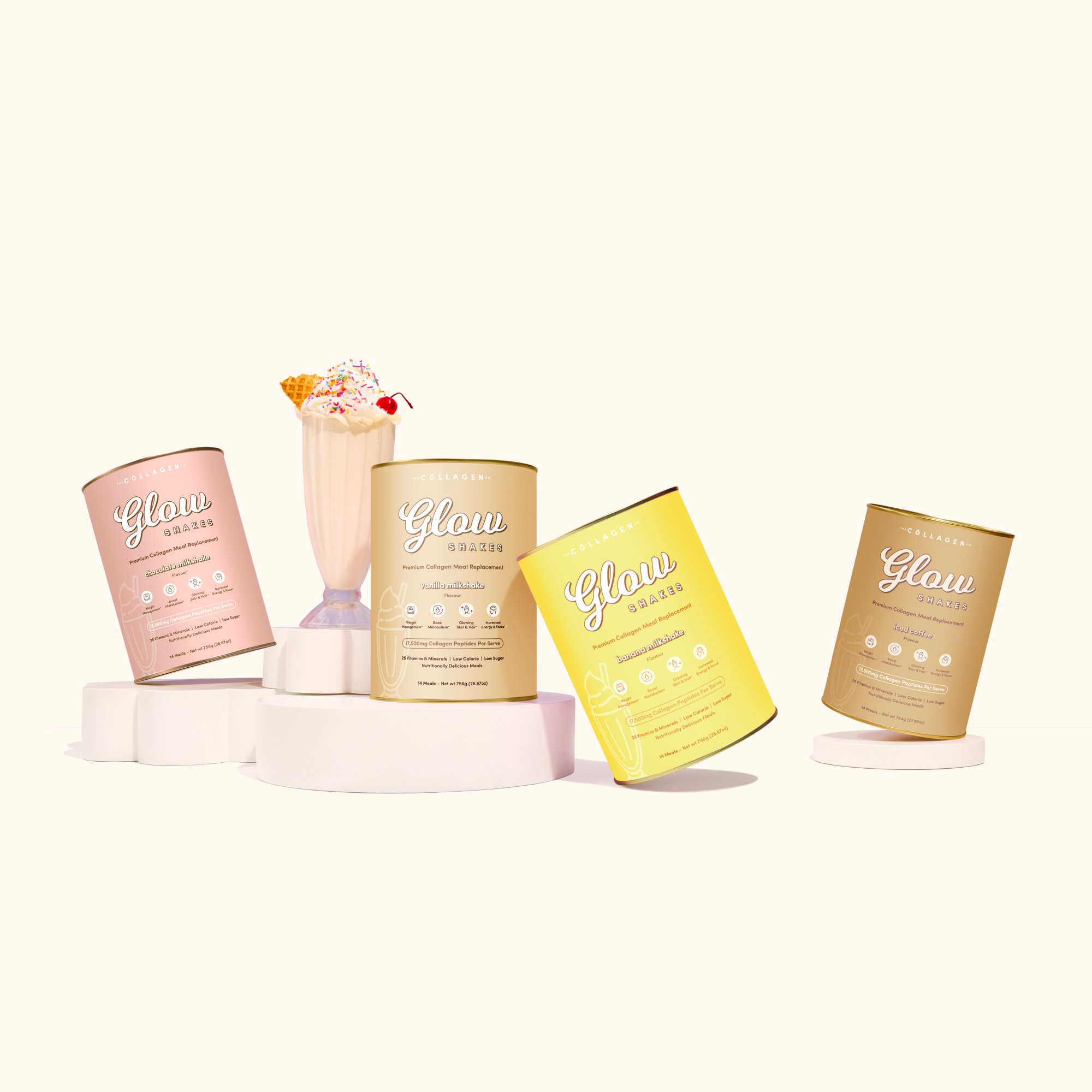 Glow Shake cans in chocolate, vanilla, banana, and iced coffee flavors are arranged in a semicircle around a vanilla milkshake topped with rainbow sprinkles and a waffle cone