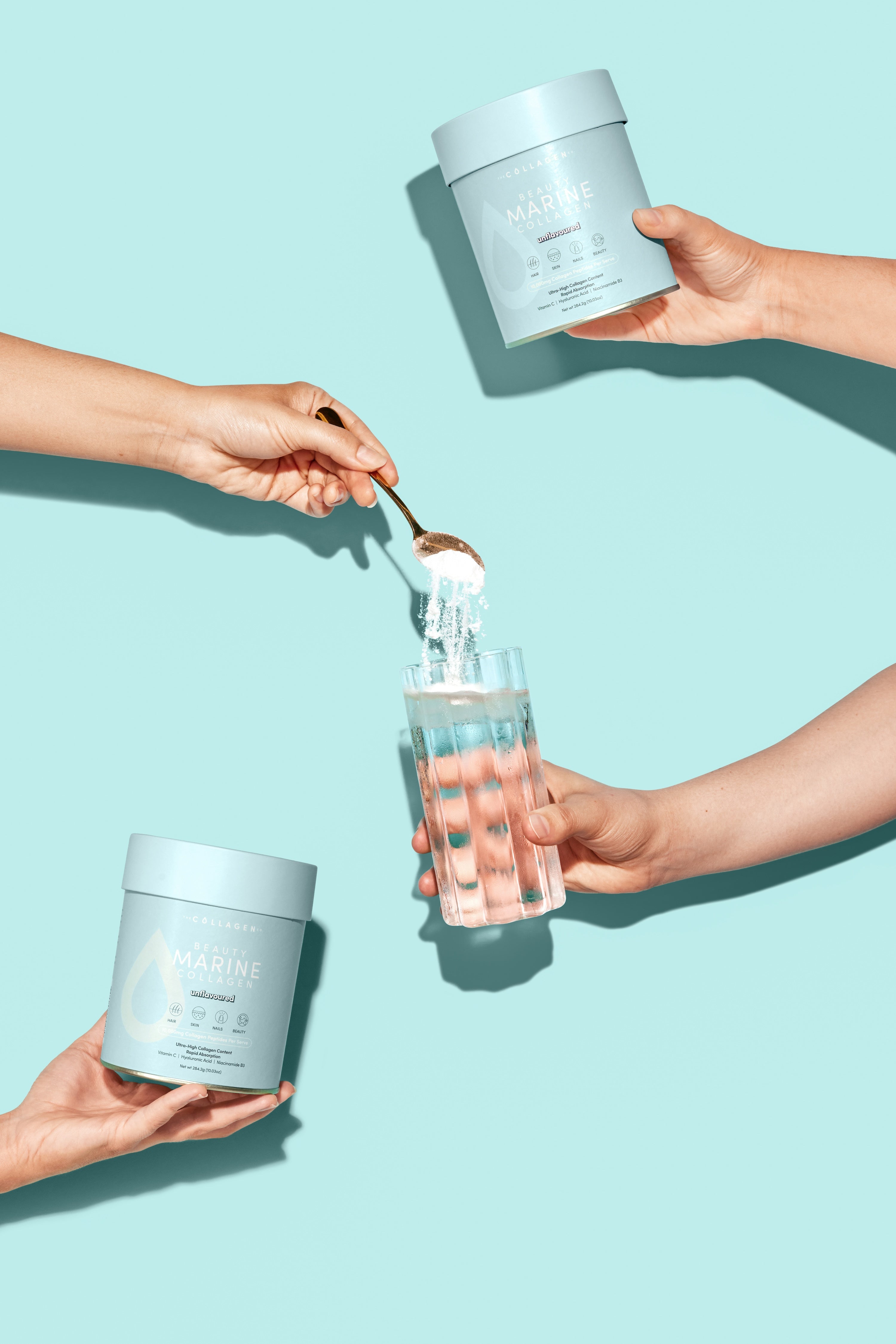 Hands holding collagen containers and a glass of water; a spoon dips collagen powder into the glass. Light turquoise background.
