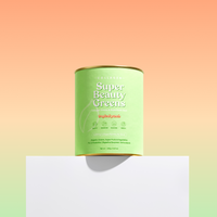 Green collagen supplement container labeled "Super Beauty Greens" on a white block, set against a gradient peach and green background.
