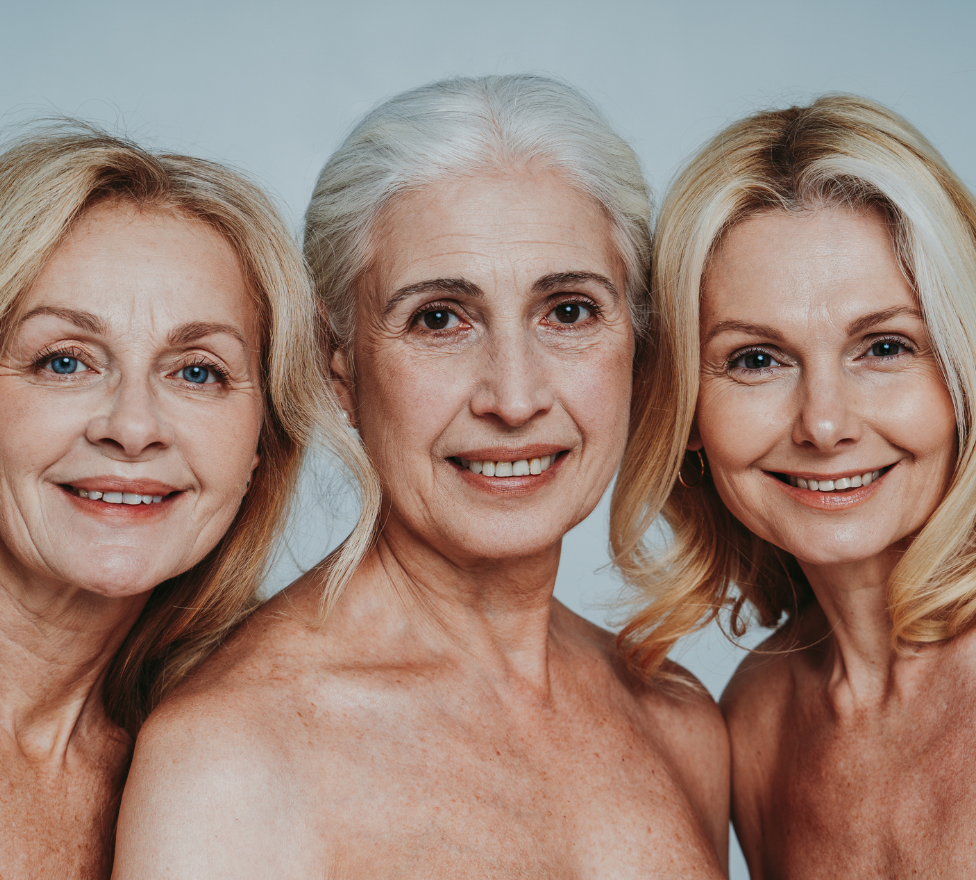 Three smiling older women with bare shoulders, showcasing natural beauty and healthy skin, emphasizing the benefits of collagen supplements.