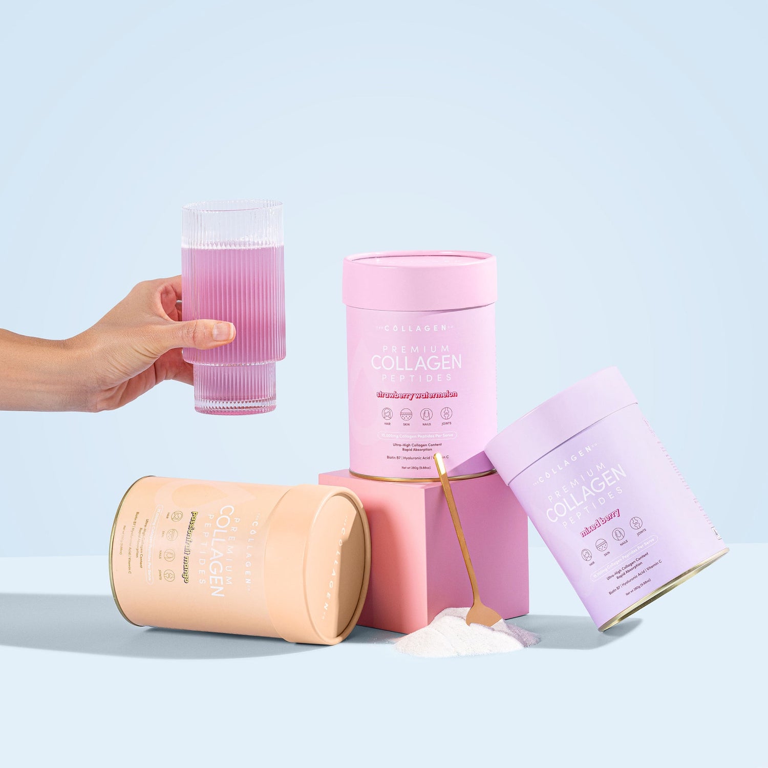 Assorted collagen supplement containers with a hand holding a pink drink, showcasing beauty and wellness products against a light blue background.