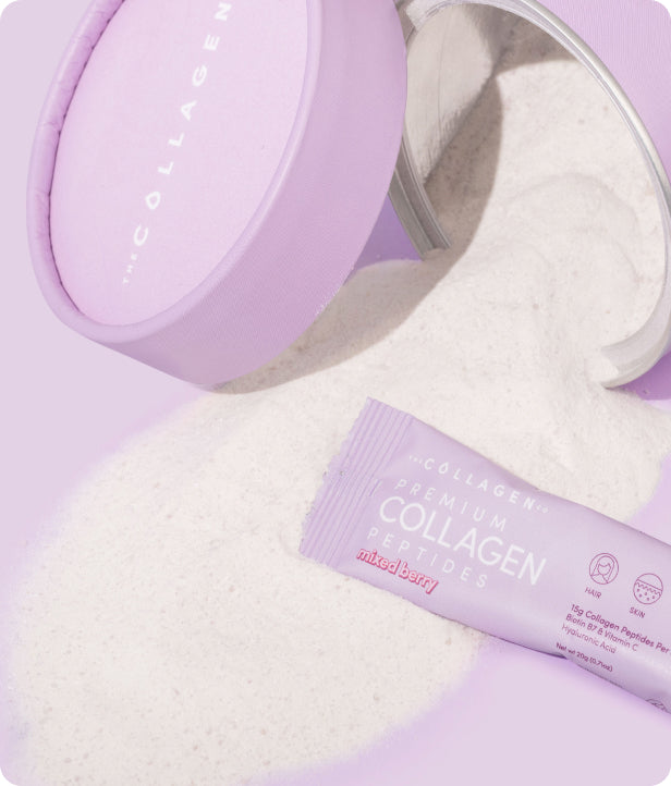 Pink container and sachet of premium collagen peptides powder, labeled "mixed berry," spilled on a pastel surface.