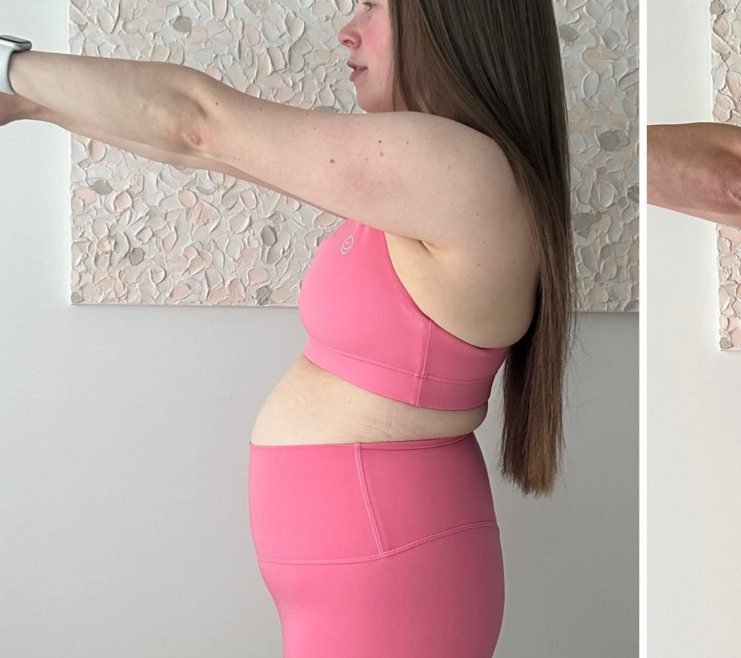 Woman in pink workout attire stands in a side pose. Long hair, textured wall background. Focus on fitness and wellness.