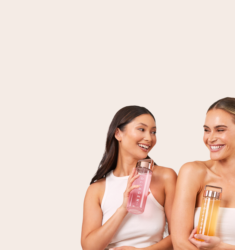 Two smiling women holding collagen bottles, one pink and one orange, against a neutral background. Focus on beauty supplements.