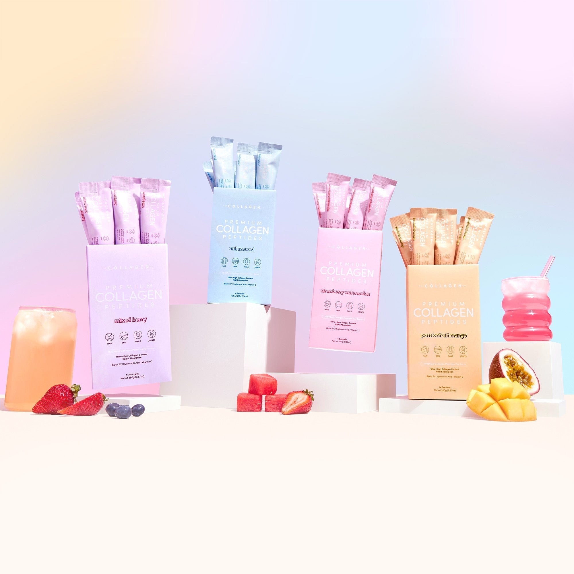 Custom Glow Getter Bundle collagen packets in pastel colors with fresh fruits and smoothie against rainbow gradient background