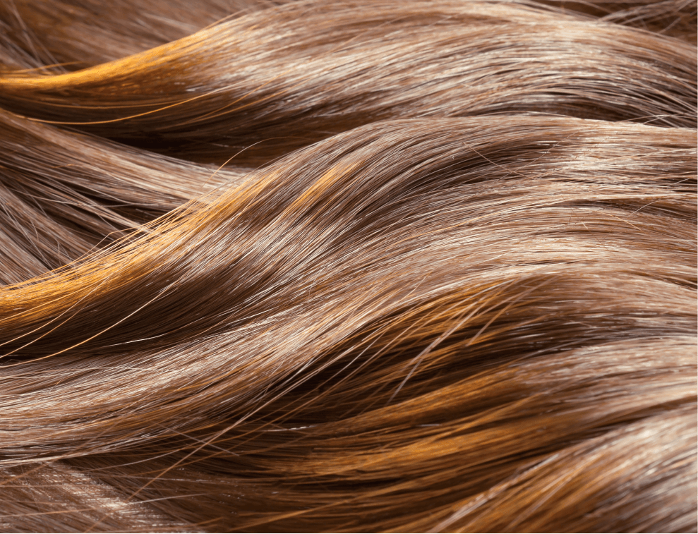Close-up of silky, wavy brown hair showcasing shine and smooth texture, highlighting beauty and hair health.