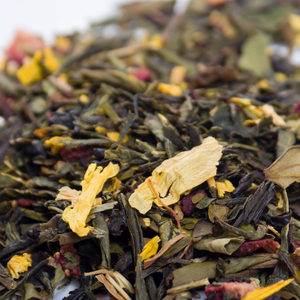 A close-up of a loose herbal tea blend with green leaves, yellow petals, and hints of red. Ideal for beauty and wellness enthusiasts.