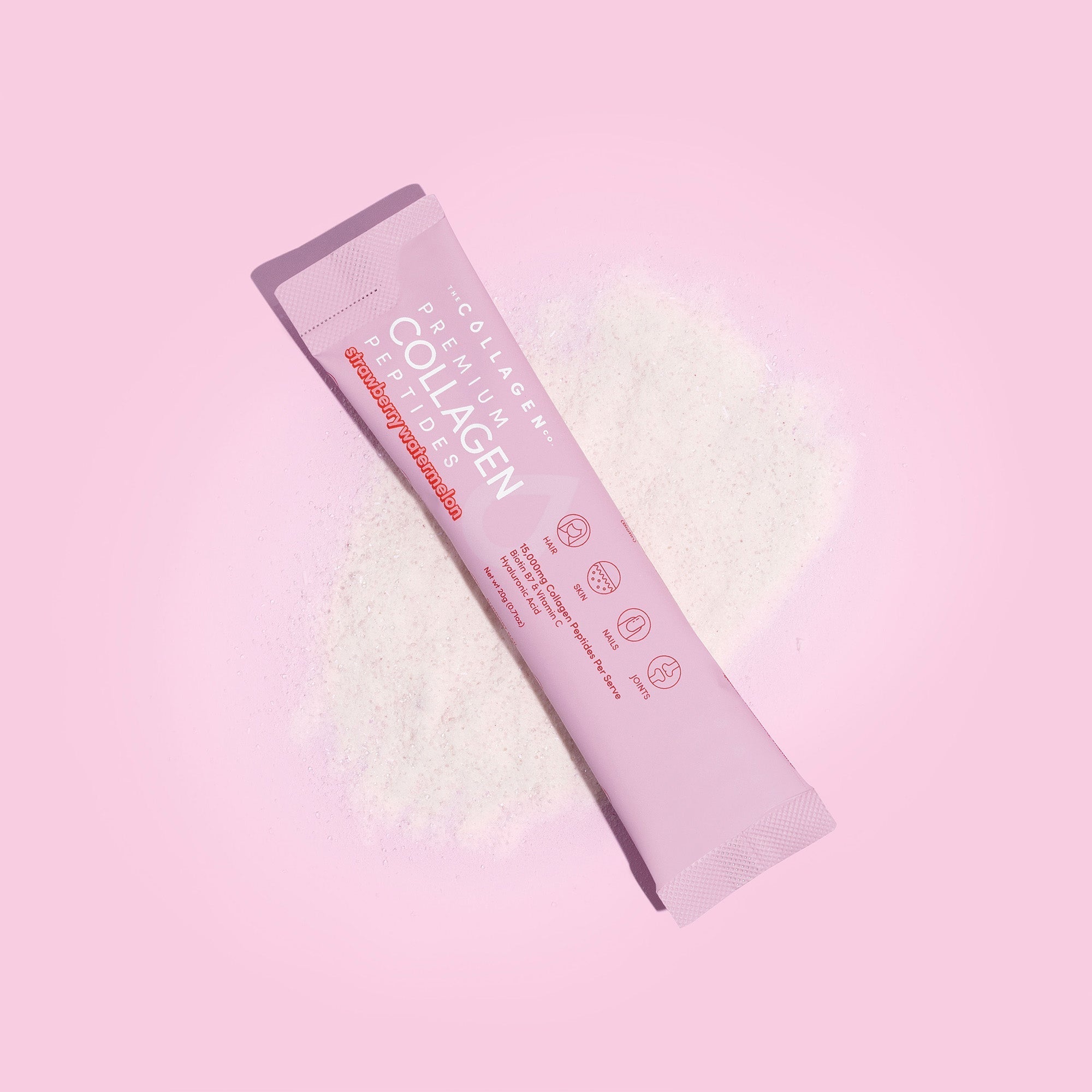 Mixed Flavours Collagen Sachets packet on pink background with white powder scatter effect