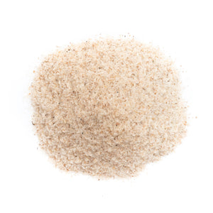 Coarse, light brown powder resembling fiber supplement on a white background; health and wellness focus.