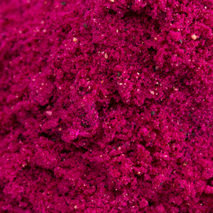 Vibrant magenta powder texture, likely a collagen supplement, rich in beauty-enhancing nutrients, captured in close-up detail.