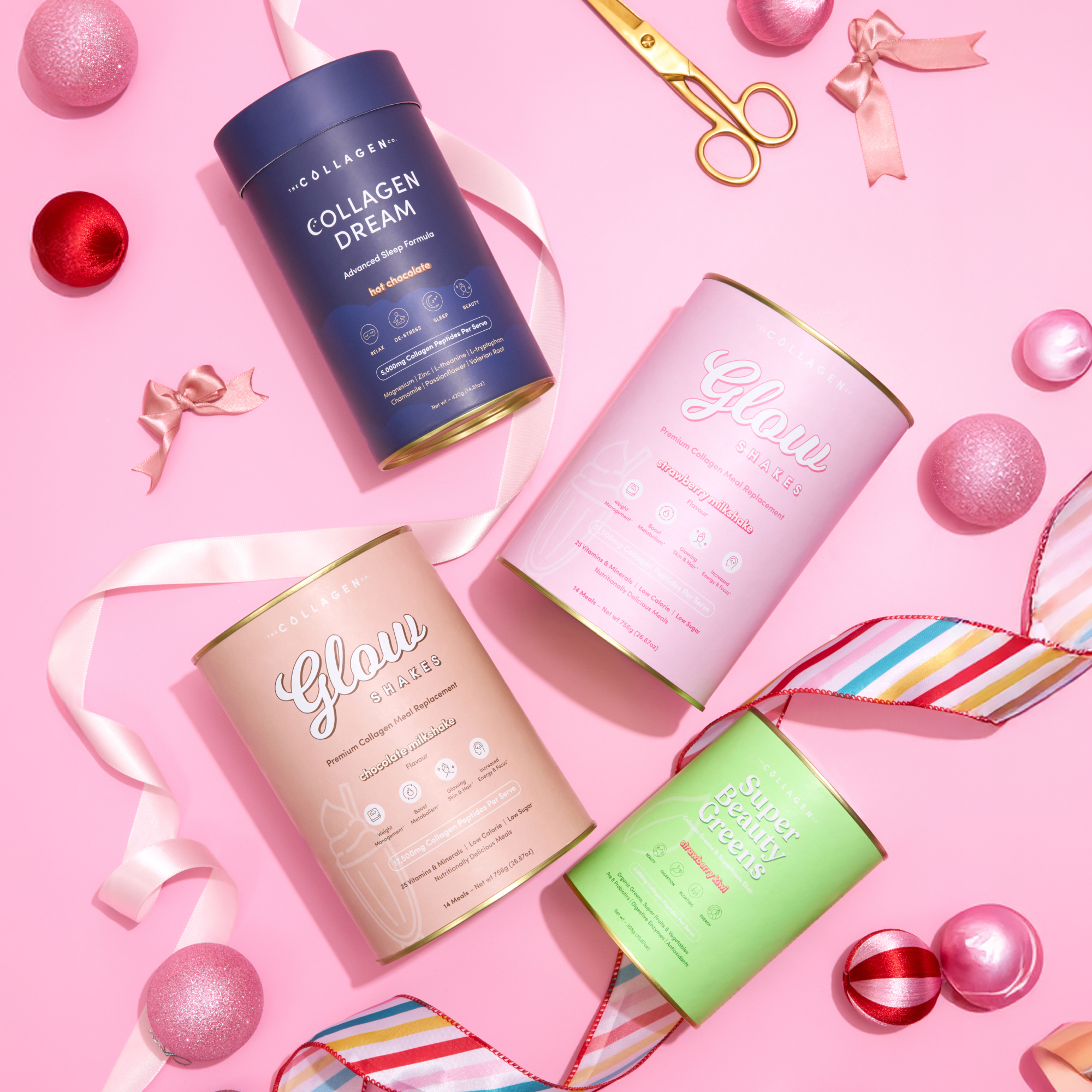 The Collagen Co.’s 2026 Reset Bundle features pastel supplement containers arranged on a pink background with ribbons, scissors, and ornaments, creating a festive vibe.