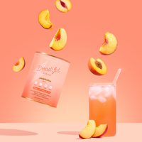 Peach-flavored drink mix can with a glass of peach juice and sliced peaches on a pink background