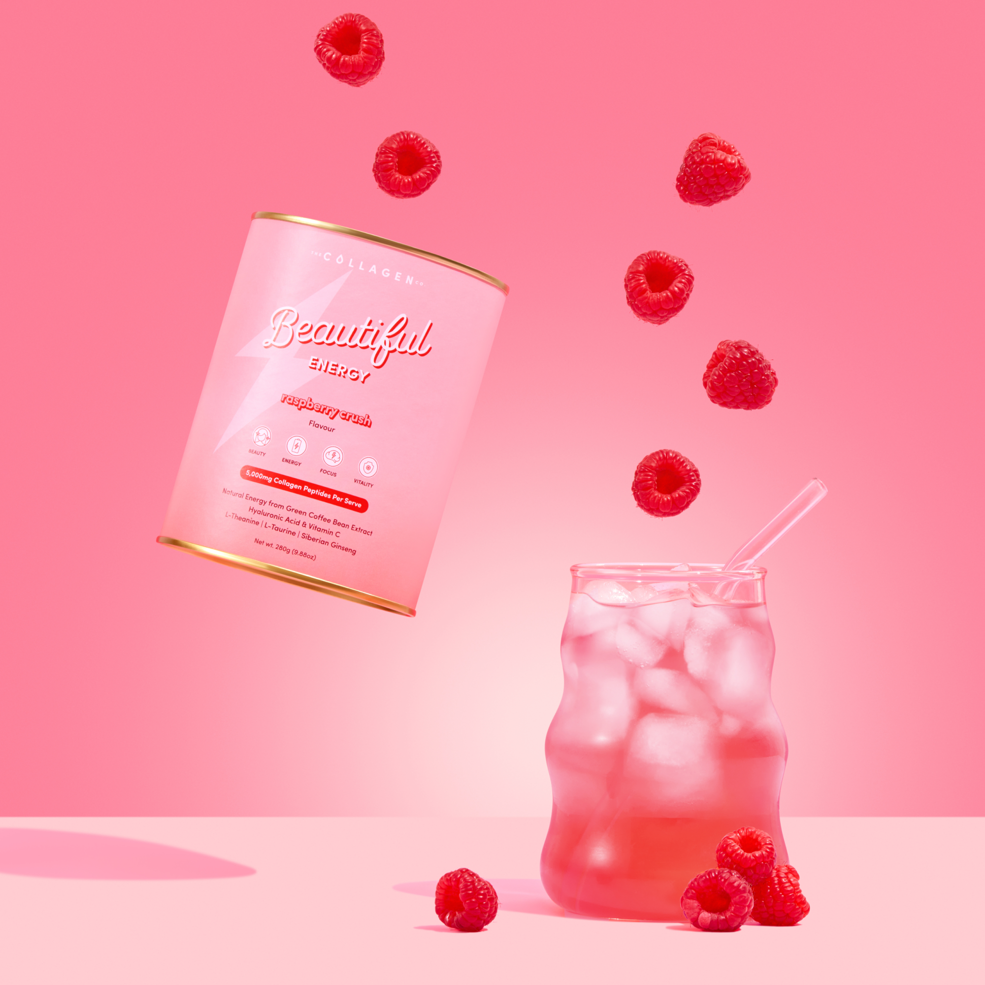 Pink drink with ice and raspberries, can labeled 'Beautiful' on a pink background