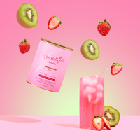 A Strawberry Kiwi Beautiful Energy canister by The Collagen Co USA floats with kiwi and strawberry slices above a pink iced drink, set against a pink gradient—highlighting hydrolysed collagen peptides for skin health.