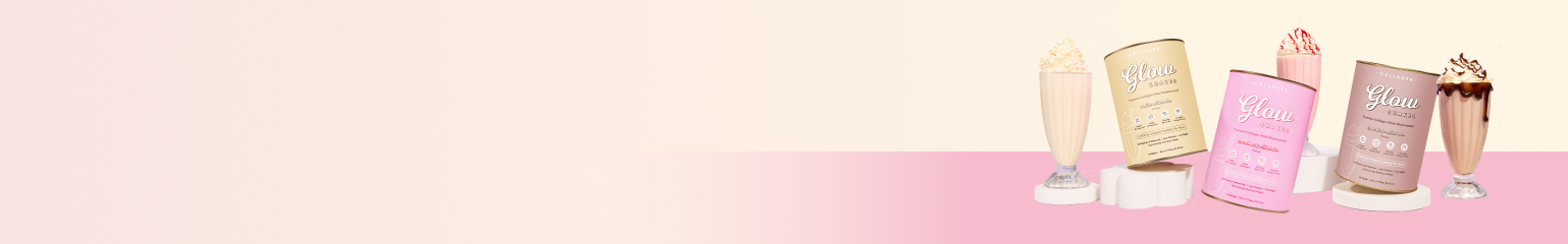 Three colorful Glow protein powder packages and three milkshakes with whipped cream are arranged on a pink and cream background, conveying a healthy and vibrant lifestyle.