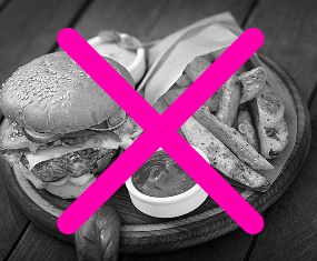 A black-and-white image of a hamburger, potato wedges, and dipping sauce on a wooden plate, overlaid with a large pink “X,” suggesting the food is not allowed or recommended.