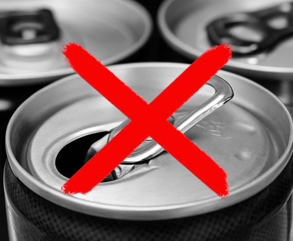 Close-up of a soda can with its tab opened, overlaid with a large red X, symbolizing prohibition or warning against consumption. Other soda cans are blurred in the background.