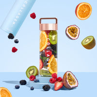 Thecollagen.co’s Infuser - 500ml, with a rose gold lid, is filled with sliced orange, kiwi, berries, and mint. Surrounded by swirling fruits on a light blue background, it’s the stylish way to infuse collagen into your daily wellness routine.