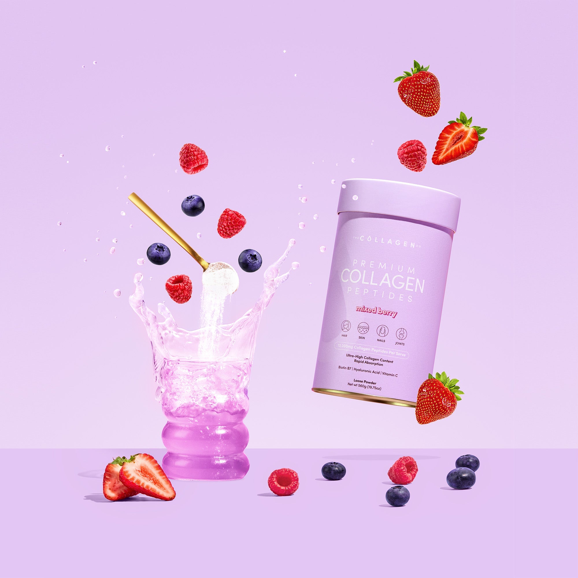 Purple background with a glass of pink liquid splashing, surrounded by floating strawberries, blueberries, and a collagen supplement container.