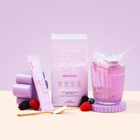 A pastel display showcases The Collagen Co. Mixed Berry Collagen Sachets (280g), featuring hydrolysed bovine collagen, a pink drink, gold spoon, mixed berries, and a single sachet against a purple background.