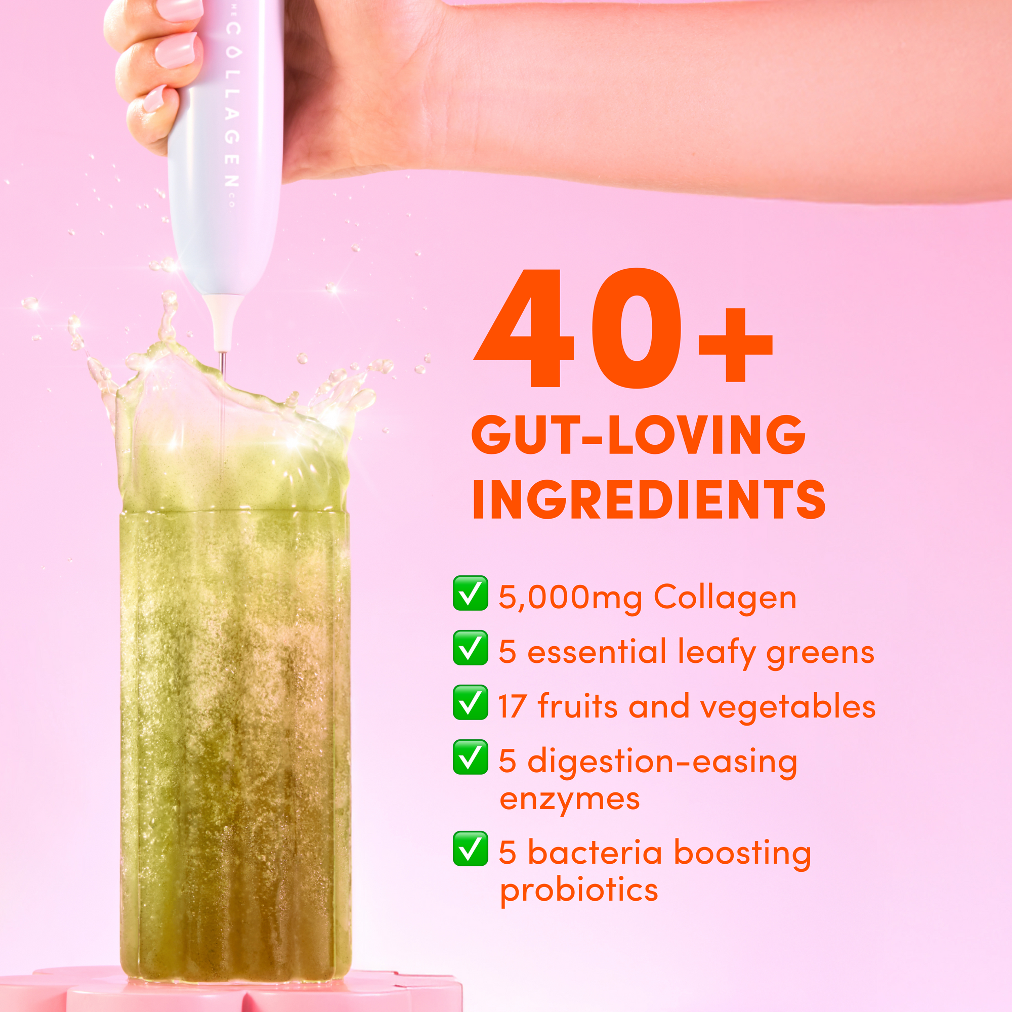 A hand blends a green smoothie in a tall glass with the pink The Collagen Co USA Tropical Punch Super Beauty Greens. Text highlights 40+ gut-loving superfoods—greens powder, hydrolysed collagen peptides, fruits, vegetables, enzymes, and probiotics—on pink.