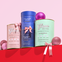 The Collagen Co. Festive Treats Wellness Kit features pastel canisters of Glow Shakes collagen meal replacements with pink satin bows, displayed among glittery ornaments on a vibrant pink background—ideal for your wellness routine.