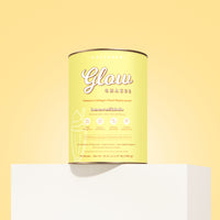 A yellow canister of The Collagen Co. Banana Milkshake Collagen Meal Replacement (756g) sits on a white pedestal against a yellow background, highlighting premium hydrolysed collagen peptides and natural flavors on its packaging.