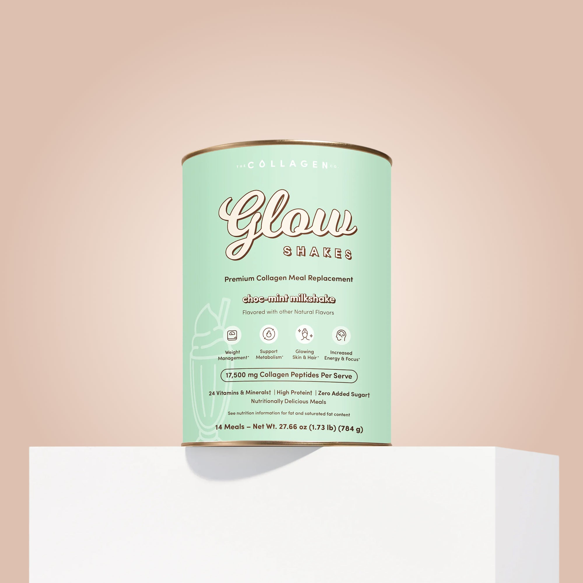 A canister of The Collagen Co. Choc-Mint Collagen Meal Replacement (784g) sits on a white platform against a beige background. The light green can features gold and white text with icons showing its collagen peptides benefits.