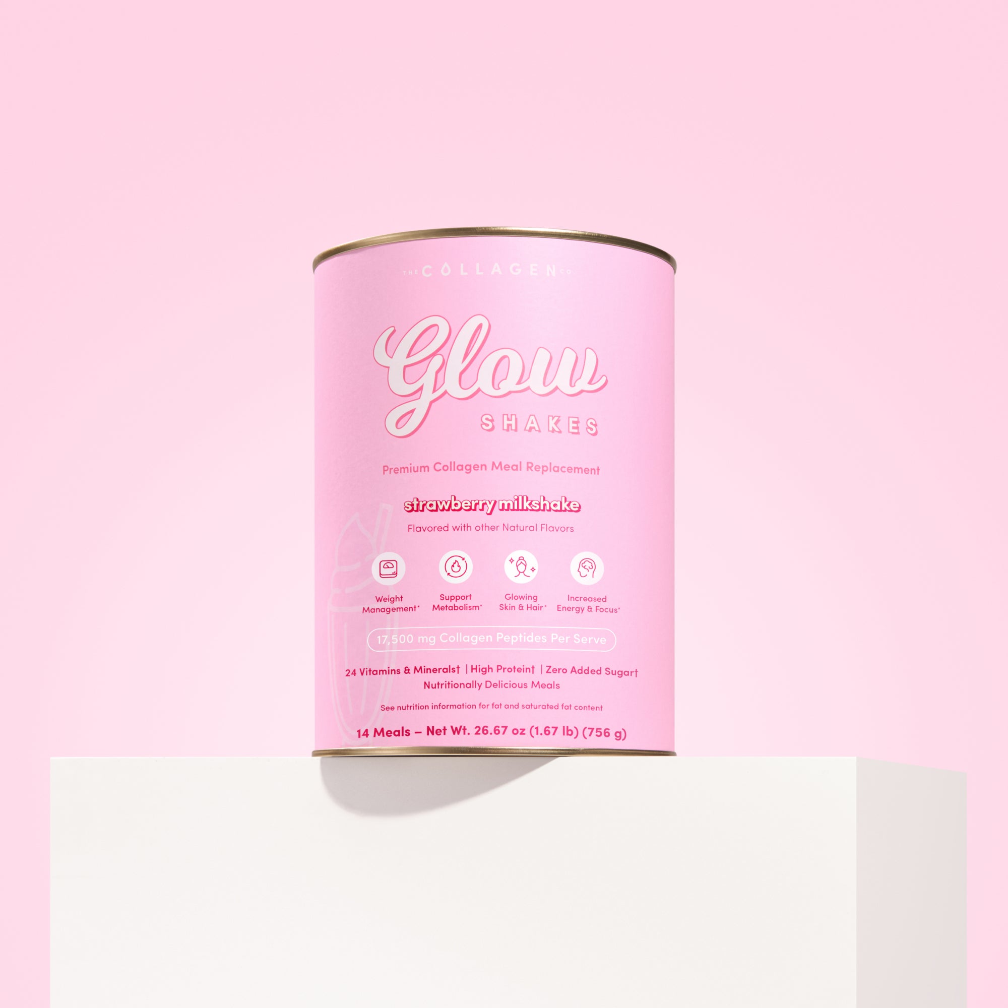 A cylindrical pink container of The Collagen Co. Strawberry Milkshake Collagen Meal Replacement (756g) sits on a white pedestal against a pink background. The packaging highlights collagen, vitamins, and no added sugar.