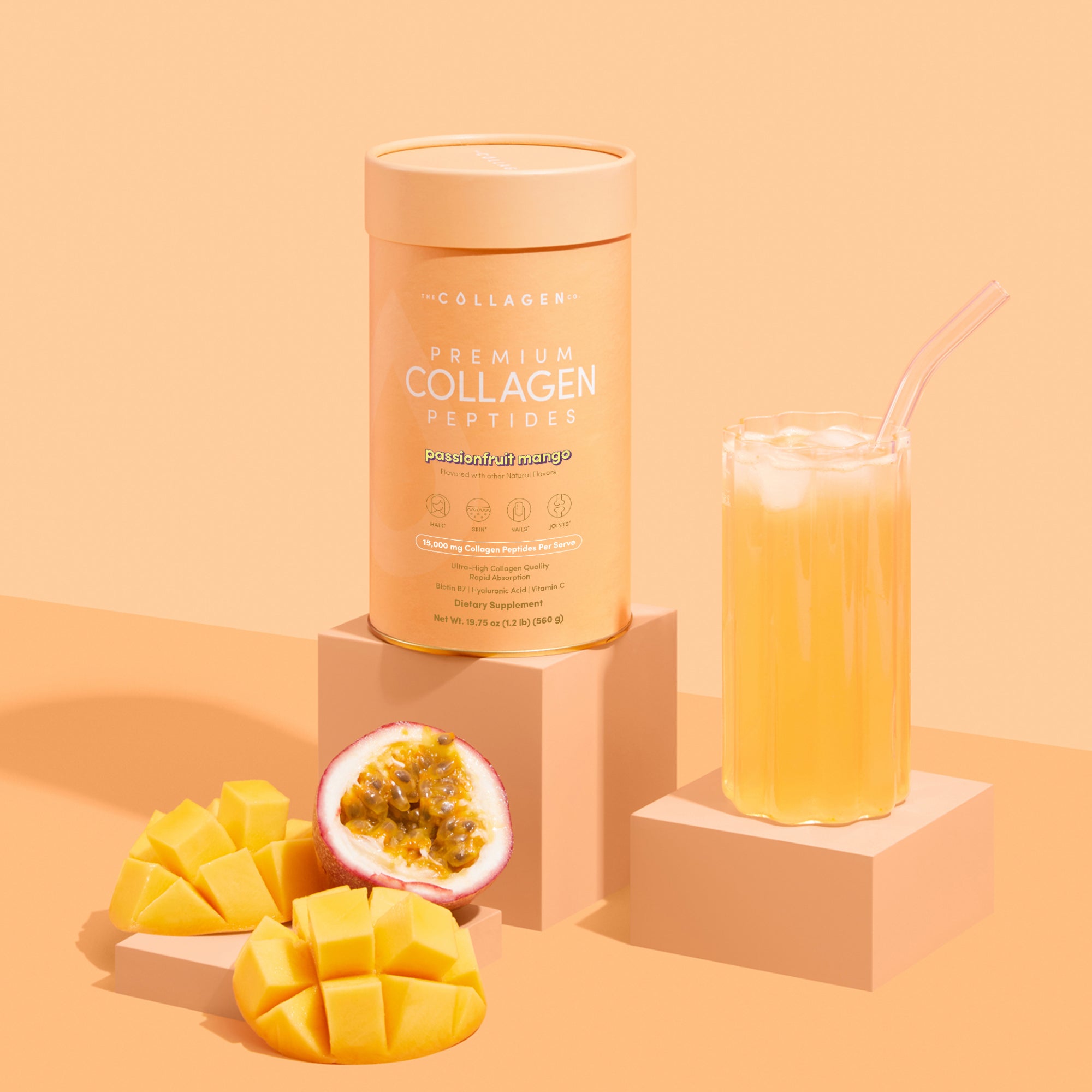 A 560g container of thecollagen.co Passionfruit Mango Collagen Powder sits beside a glass of iced juice, mango slices, and passion fruit, emphasizing its premium hydrolysed bovine collagen for anti-ageing benefits.