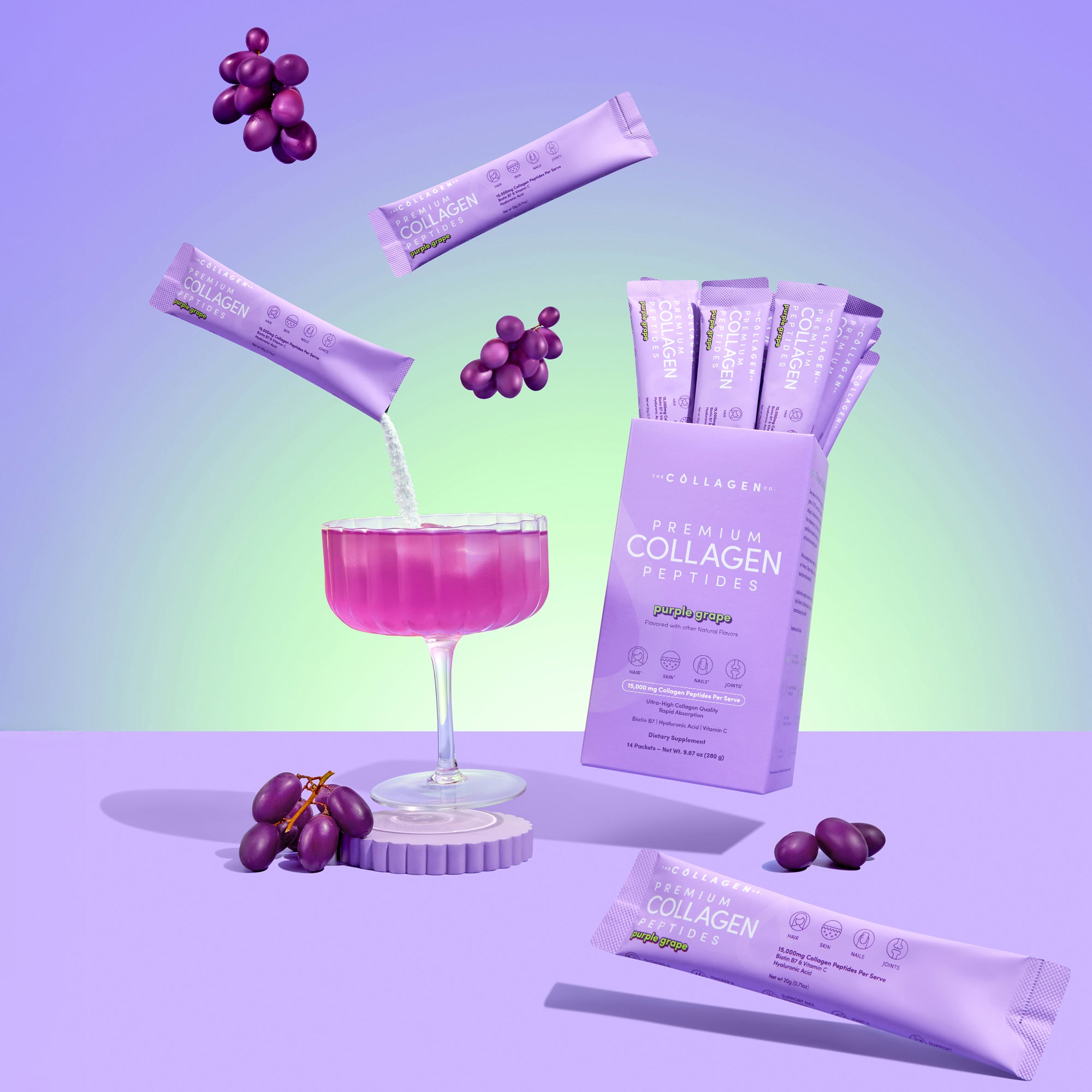 A chic glass of purple grape drink with bunches of grapes and floating The Collagen Co USA Purple Grape Collagen Sachets, set beside a 280g box on a pastel purple background.