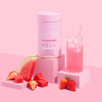 Collagen powder container with a glass of pink drink, watermelon, and strawberries on a pink background