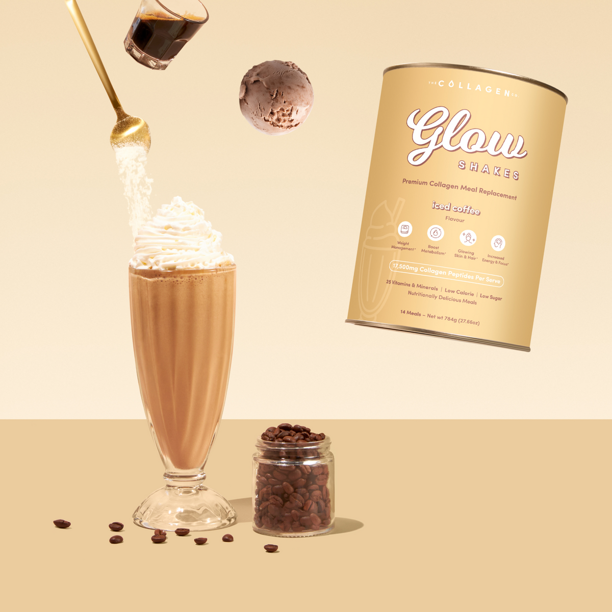 A glass of Iced Coffee Collagen Meal Replacement topped with whipped cream, coffee beans nearby, a jar of beans, a scoop of coffee powder, and the 784g canister are arranged on a beige background.
